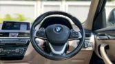 2020 BMW X1 2.0 sDrive20i xLine — steering and dashboard, driver view
